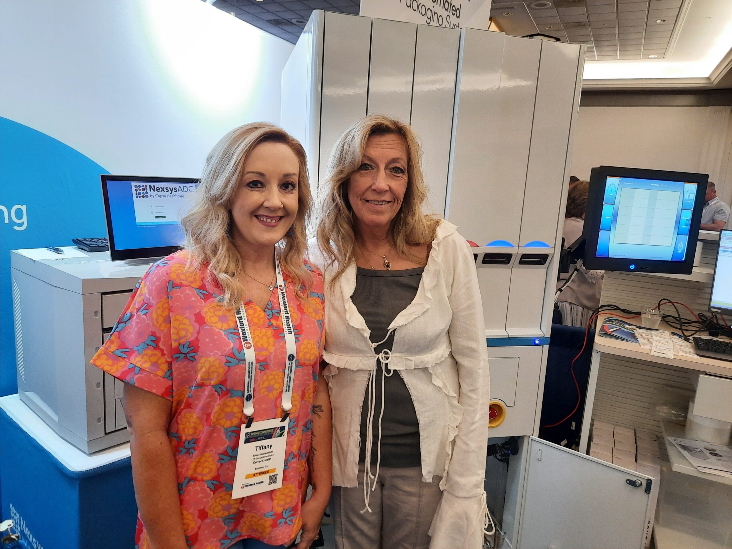 Two Corrections Nurses with NexPak Automated Pill Packaging Machine and NexsysADC